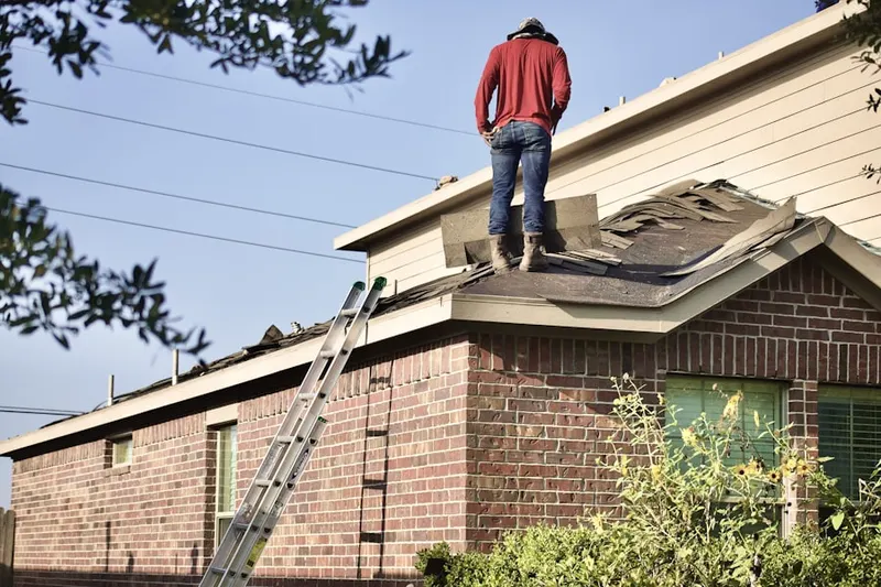 Professional roofer working on a residential roof in Davidson